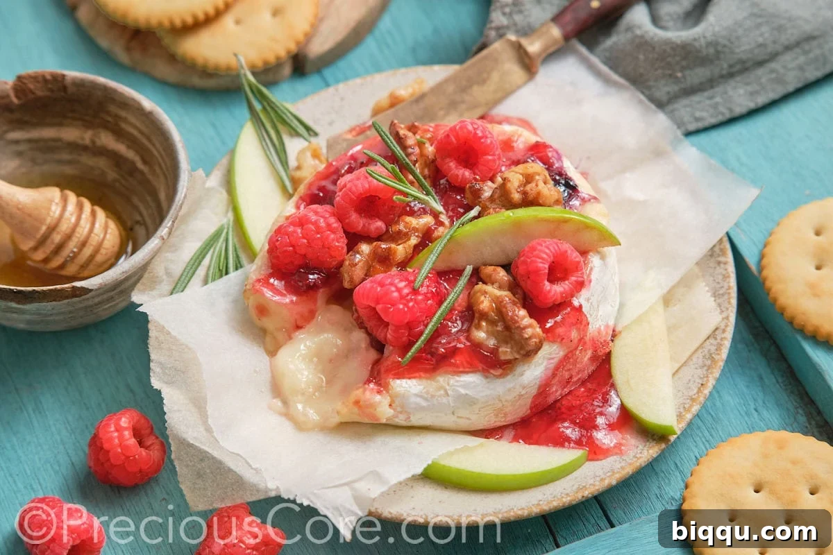Round baked brie and fruit preserves.