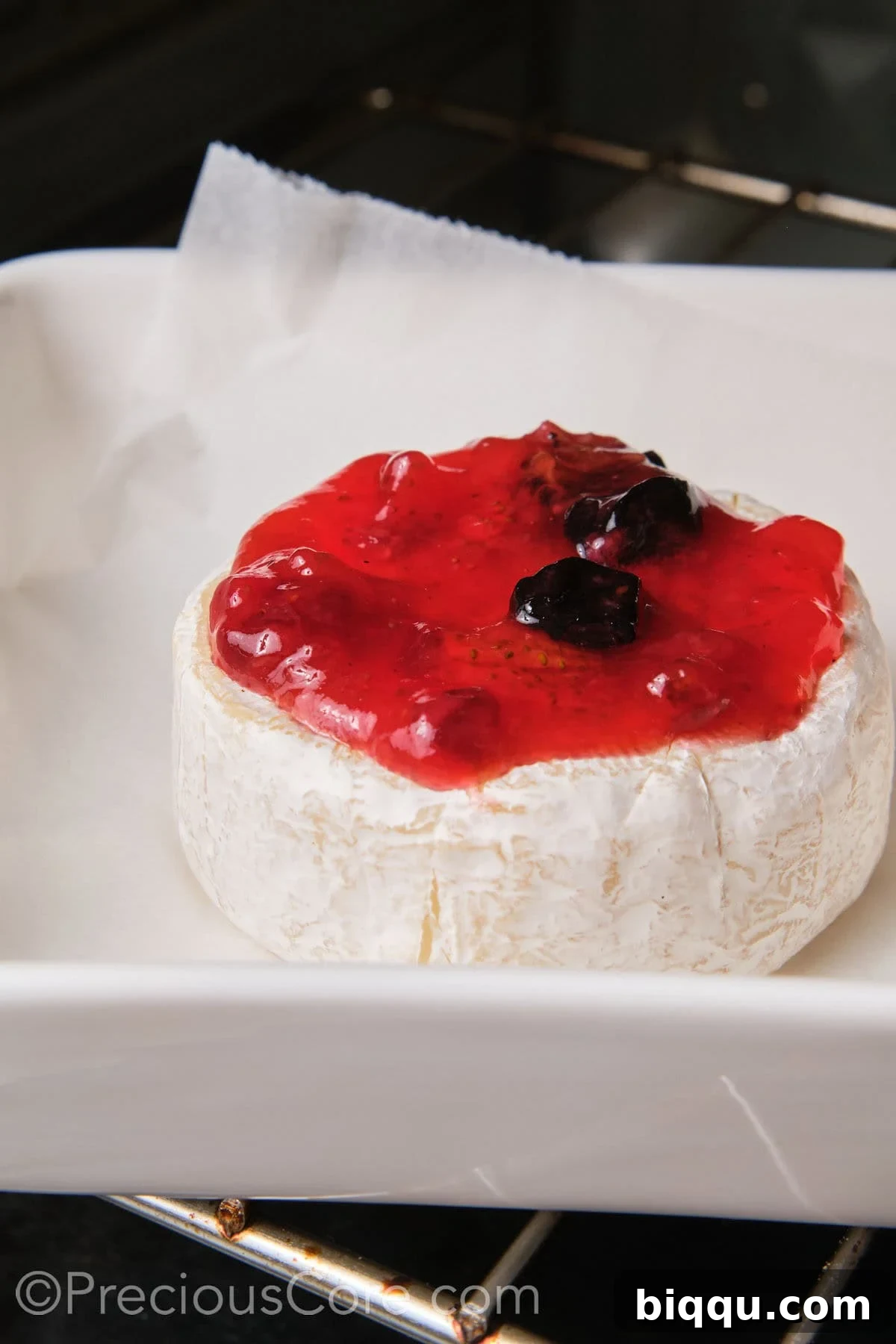 Baked Brie and fig preserves in the oven.