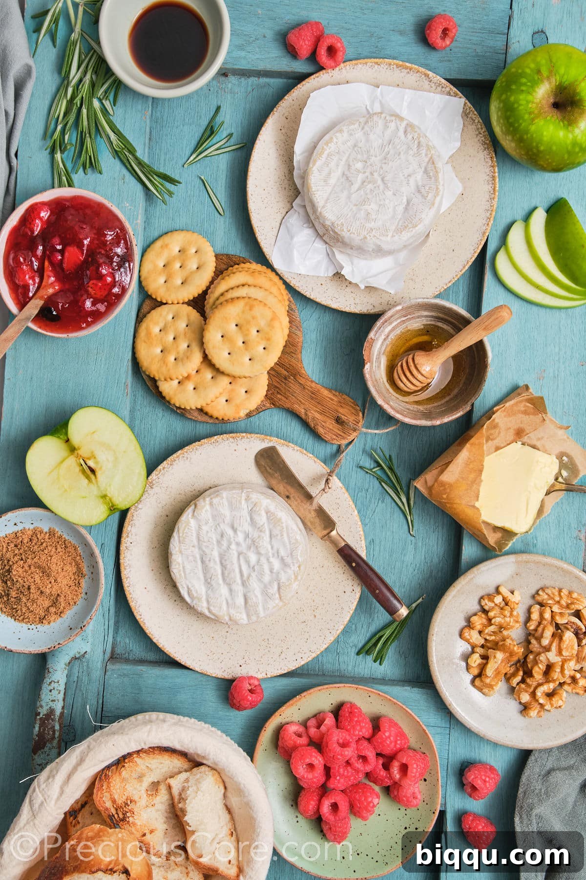 Baked brie and preserves ingredients on a board.