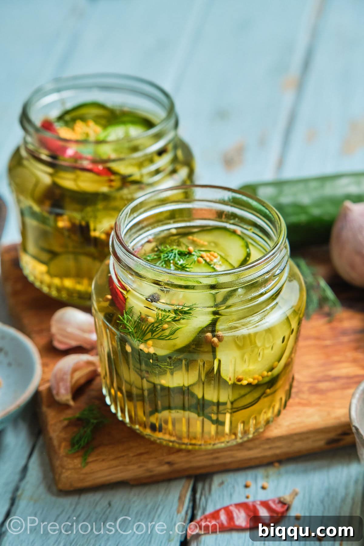 Two mason jars of homemade quick pickled cucumbers.