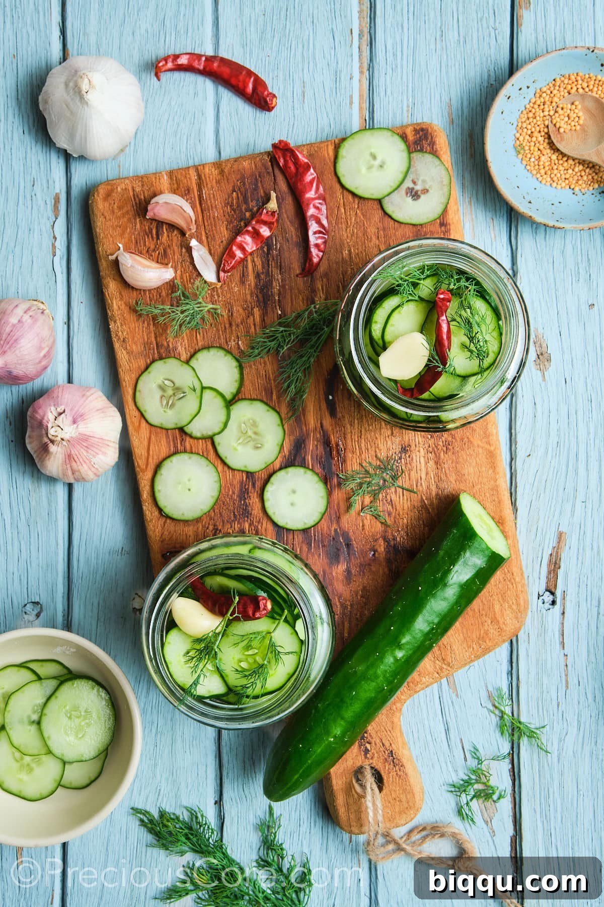 Sterilized jars with cucumber slices and other ingredients.