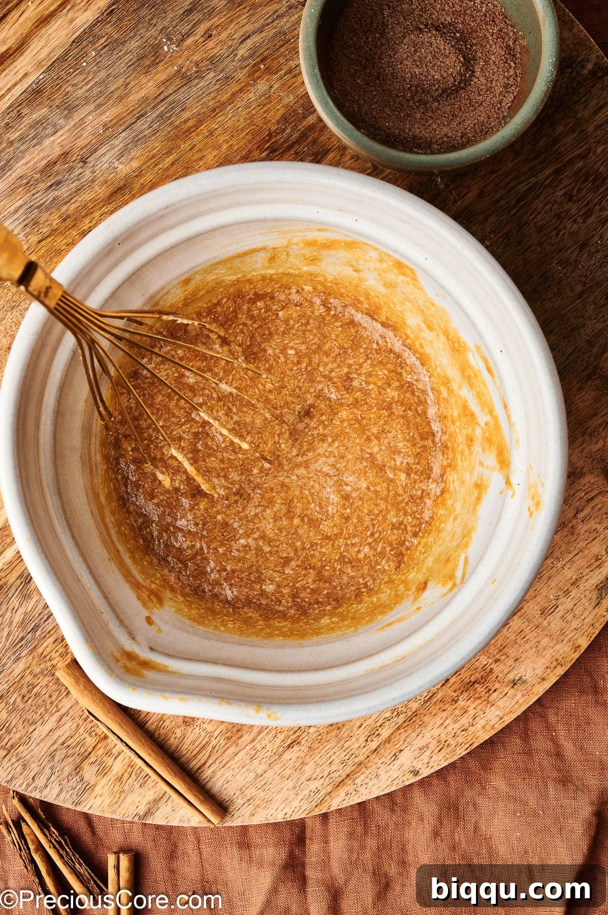 Whisked wet ingredients for pumpkin doughnuts or muffins.