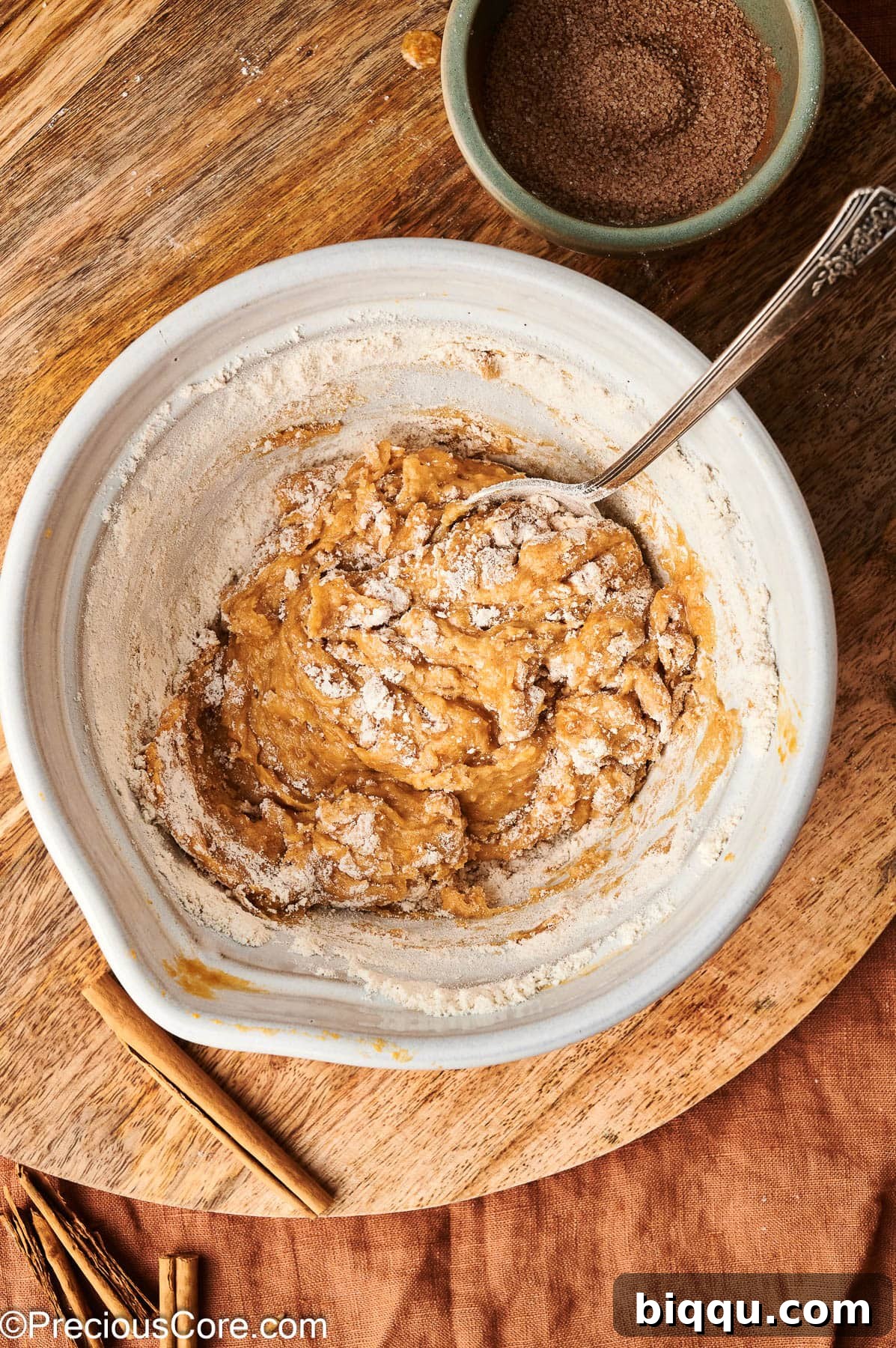 Mixing flour with pumpkin puree and other ingredients.