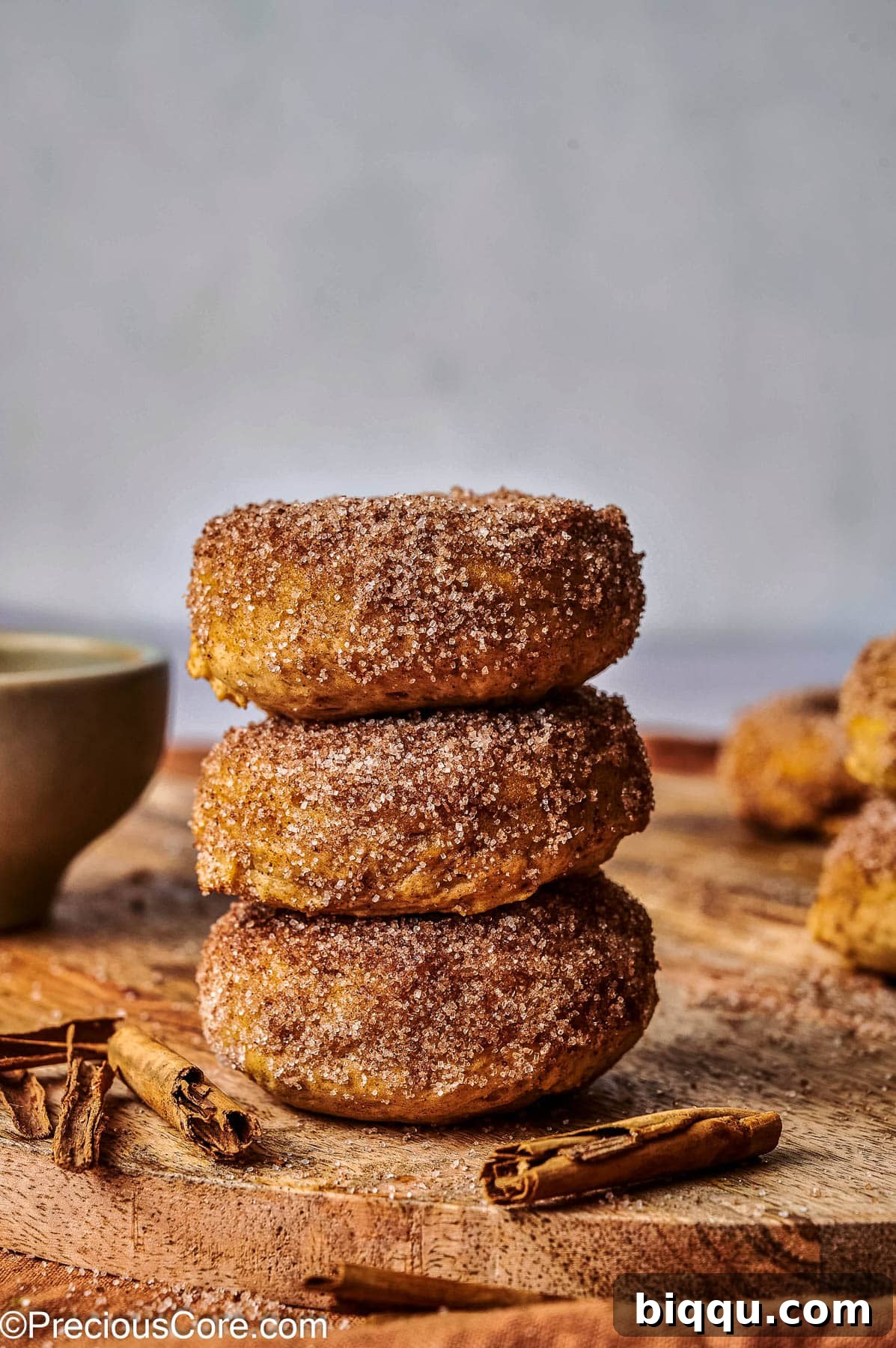 Pumpkin spice doughnuts stacked on each other.