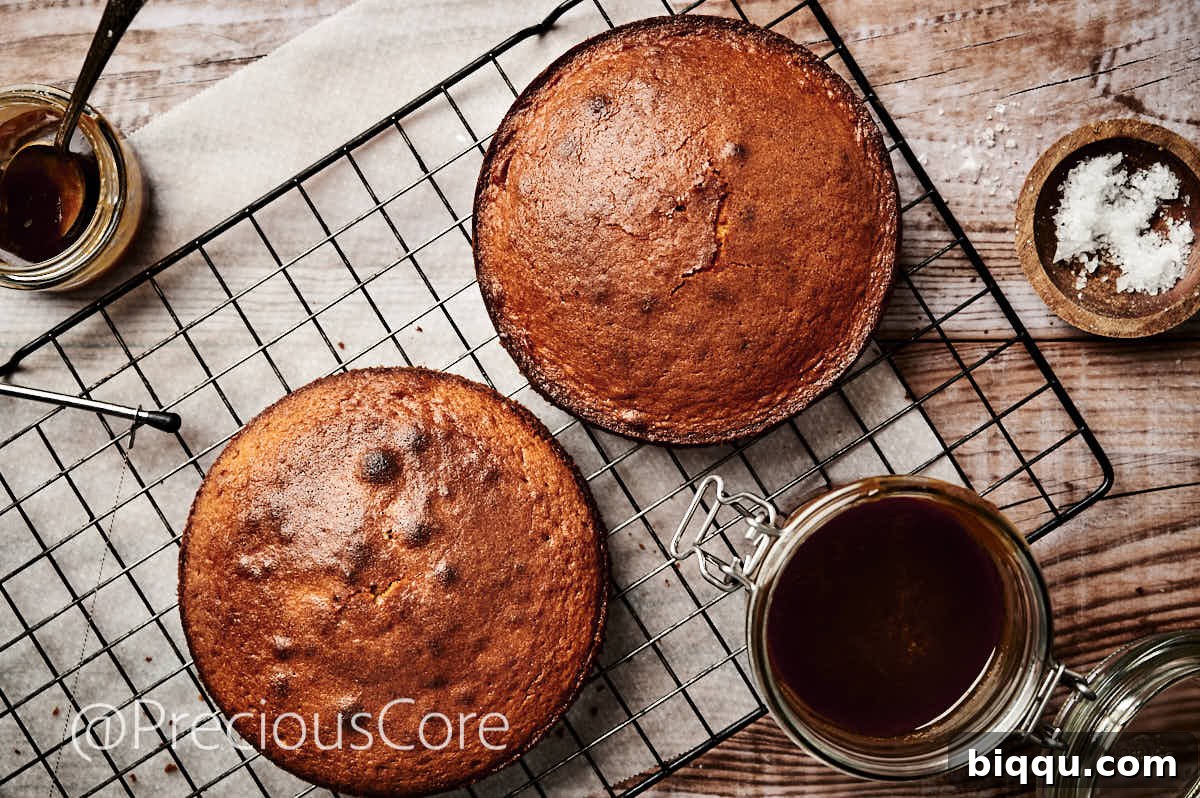 Two perfectly baked 8-inch cake layers, cooling gently on a wire rack, ready for frosting.