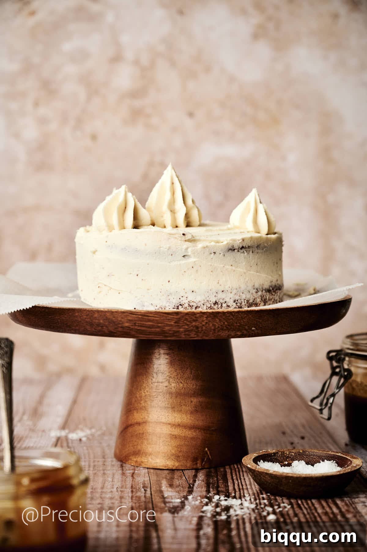 A freshly assembled Salted Caramel Cake, topped with piped caramel frosting, showcasing elegant decorative details.