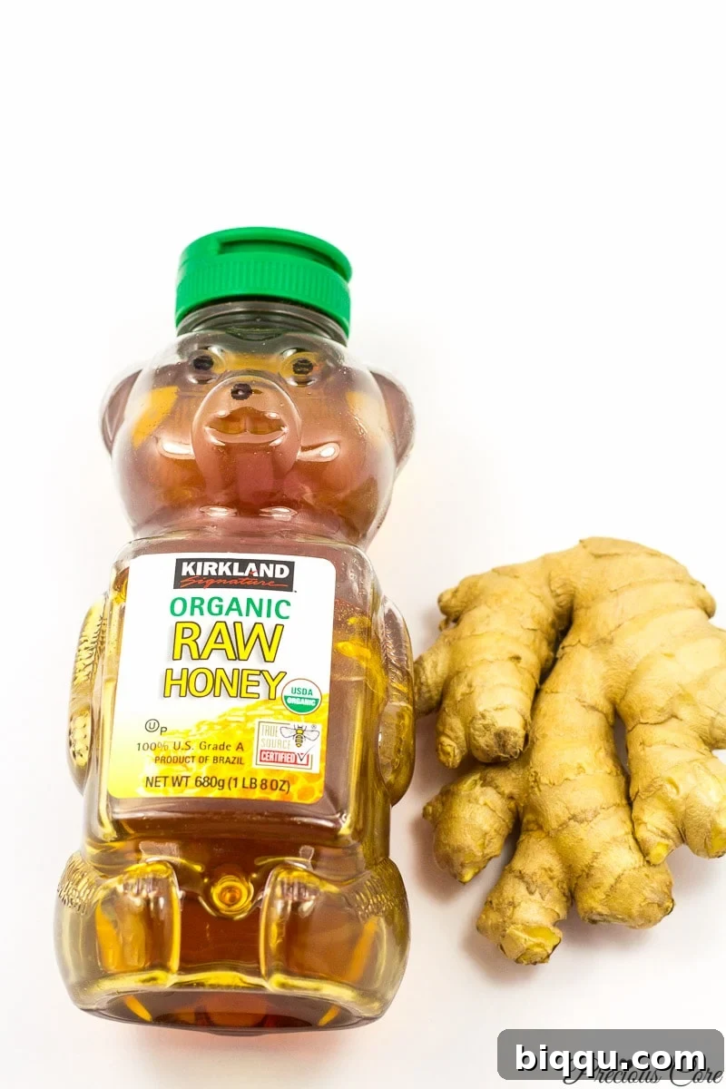 Ingredients for ginger drink: fresh ginger root and a jar of honey.