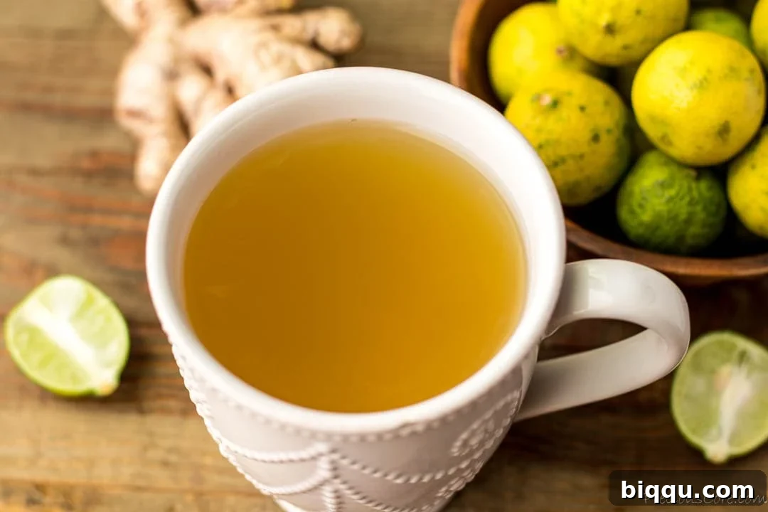 Landscape image of ginger tea in a rustic mug, indicating comfort.