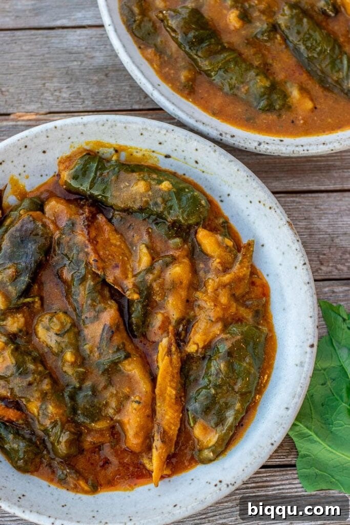 A vibrant bowl of Ekwang, showcasing its rich texture and color, garnished with fresh ingredients.