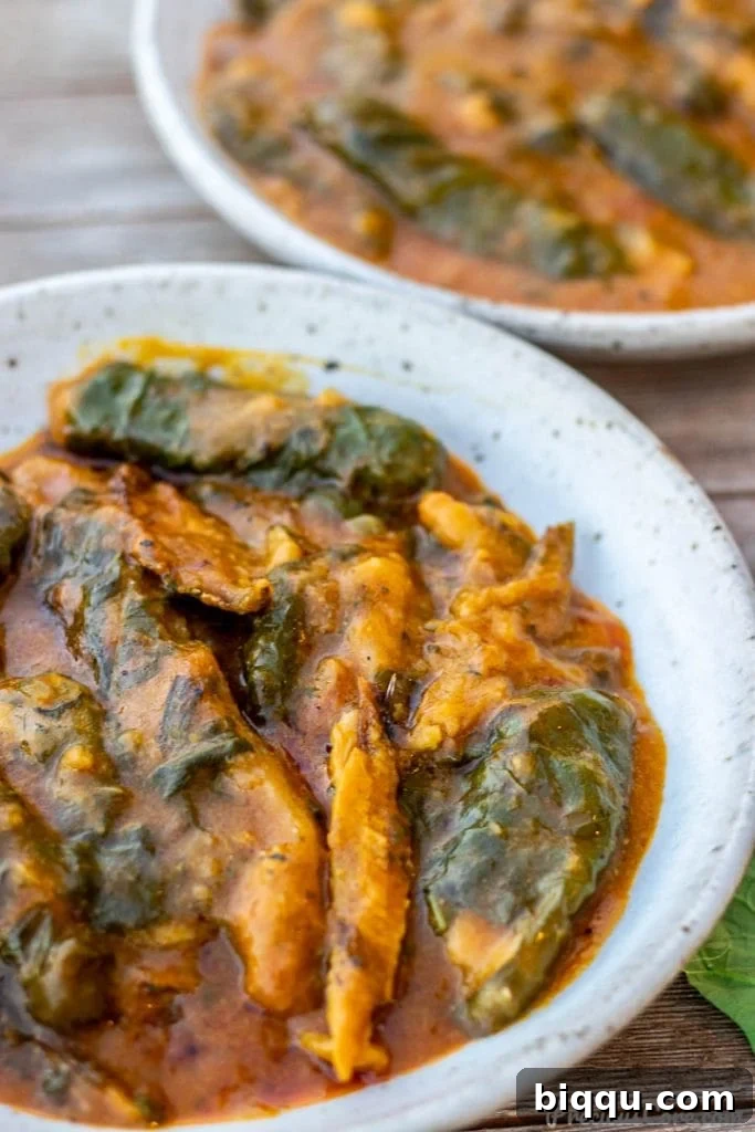 Close-up shot of Ekwang served on a plate, highlighting the individual wraps and the rich sauce.