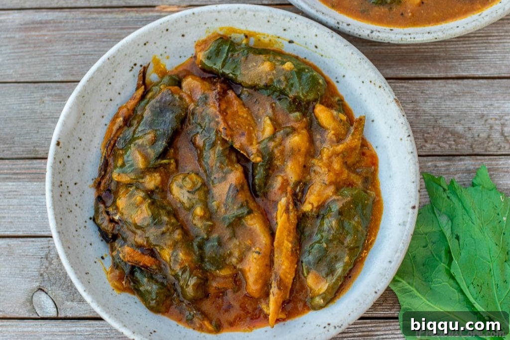 A beautifully presented pot of Ekwang, ready to be served, showcasing the rich colors and textures.