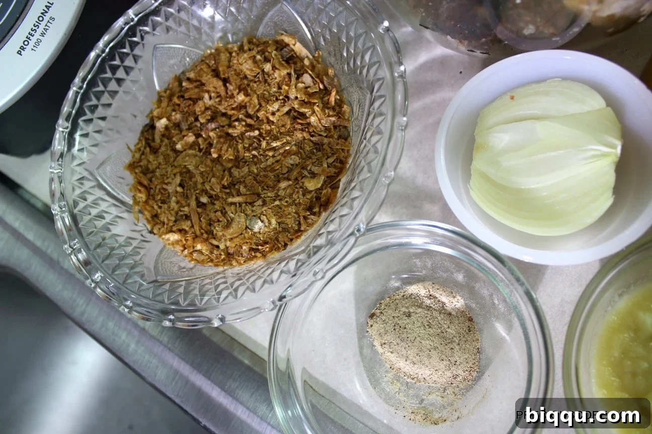 A spread of fresh Ekwang ingredients on a kitchen countertop, including cocoyams, leaves, palm oil, and spices.