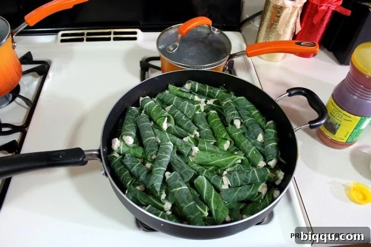 Neatly wrapped cocoyam paste parcels arranged in a skillet, ready for the simmering process.