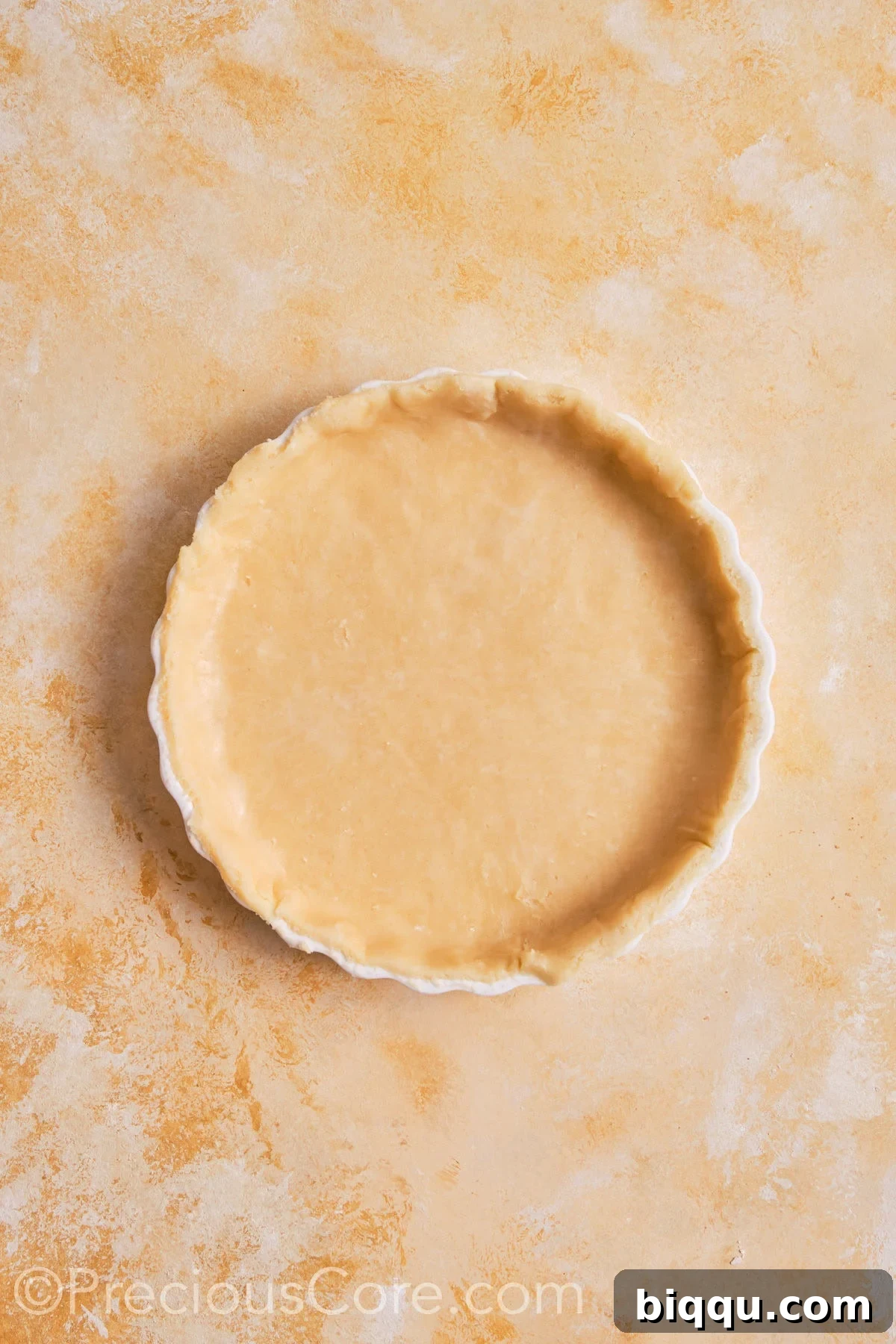 Pumpkin pie dough fitted into pie dish.