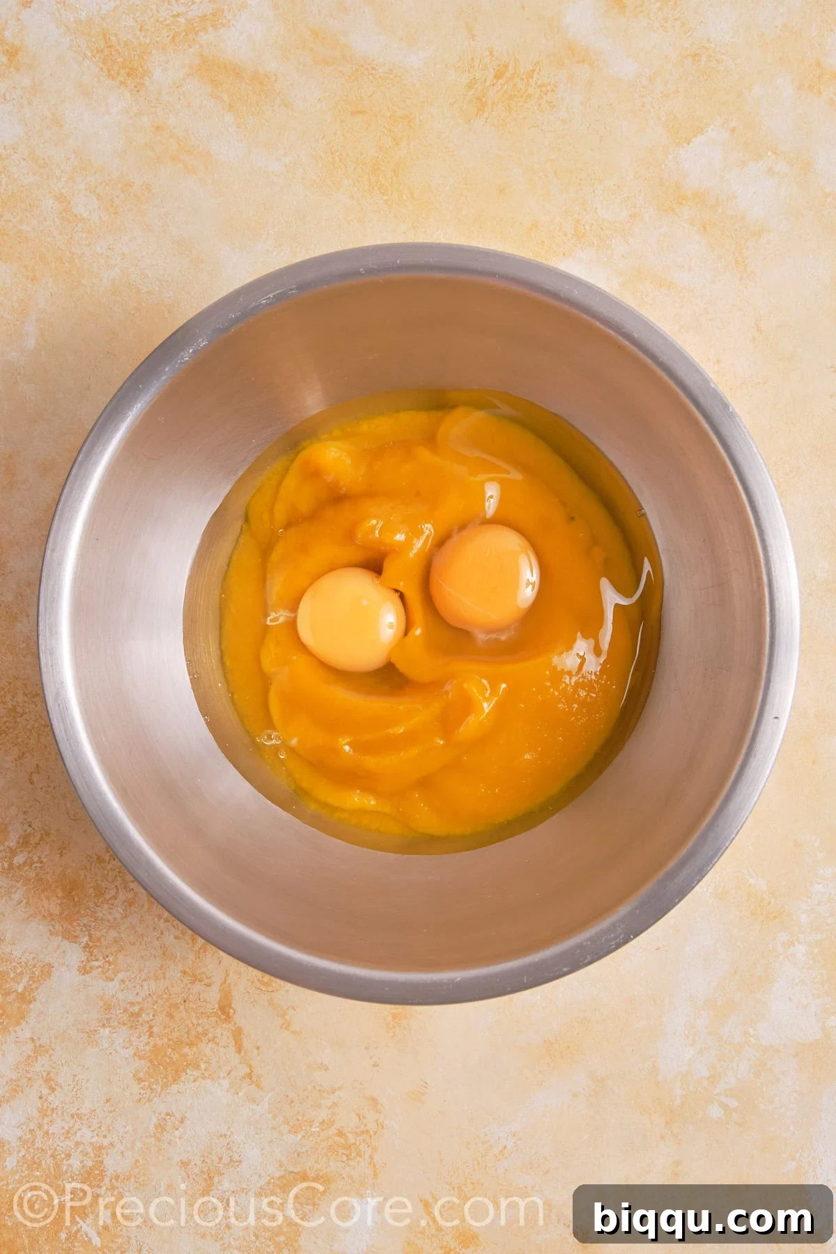 Eggs and pumpkin puree in a bowl.