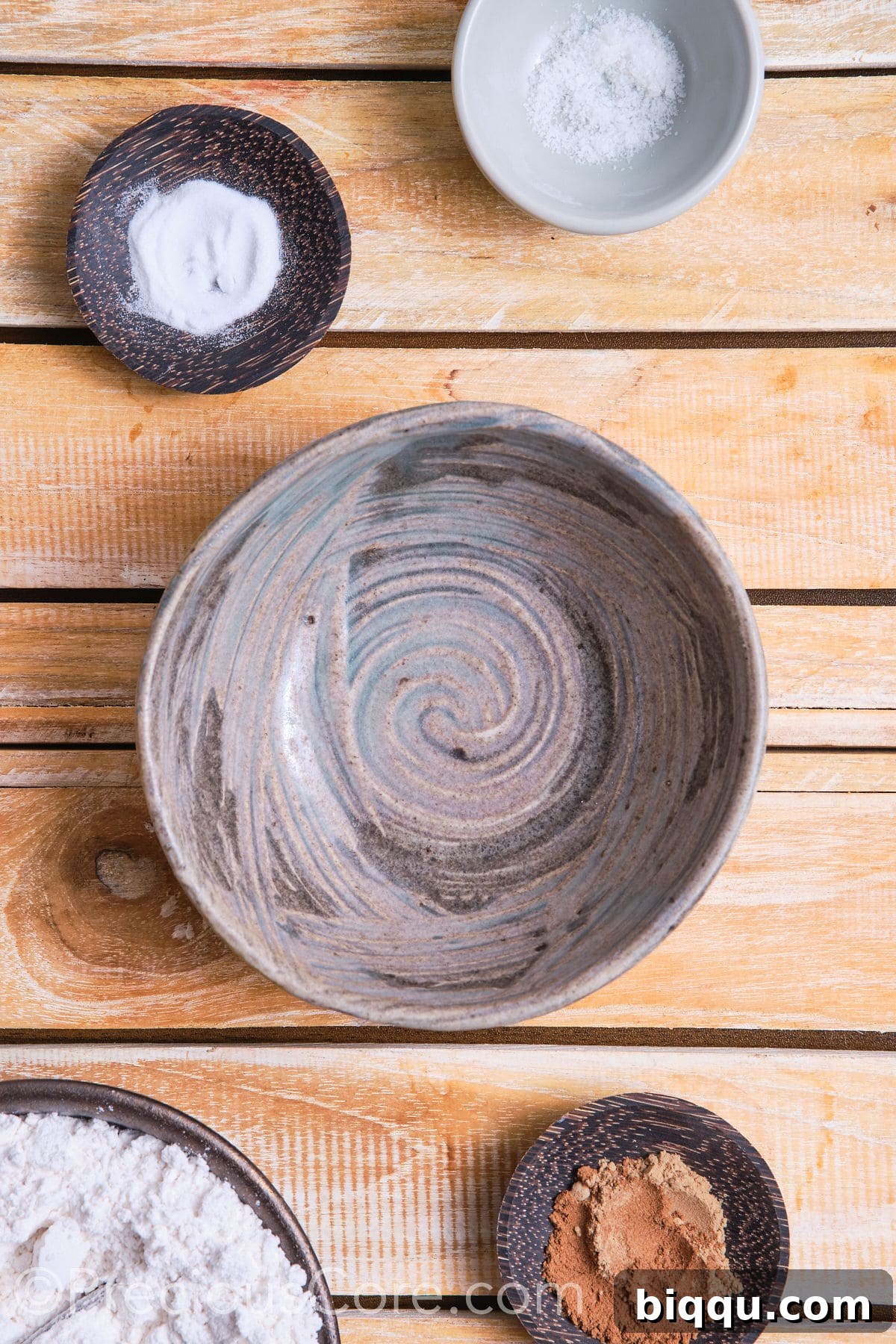 A mixing bowl filled with the dry ingredients for the chocolate chip cinnamon cookies, including flour, spices, and leavening, meticulously measured and ready to be whisked.