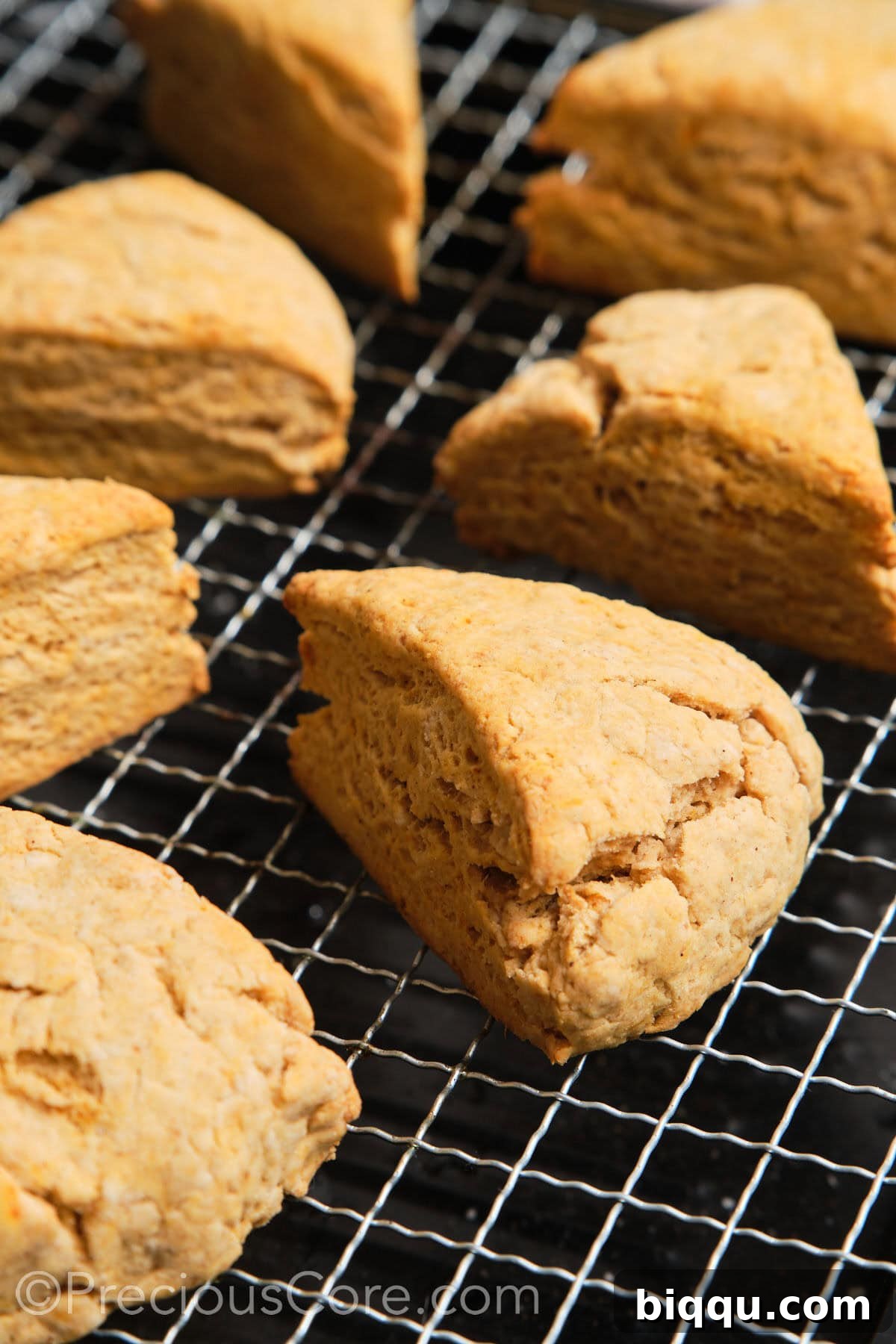 Freshly baked scones cooling on a wire rack before glazing.