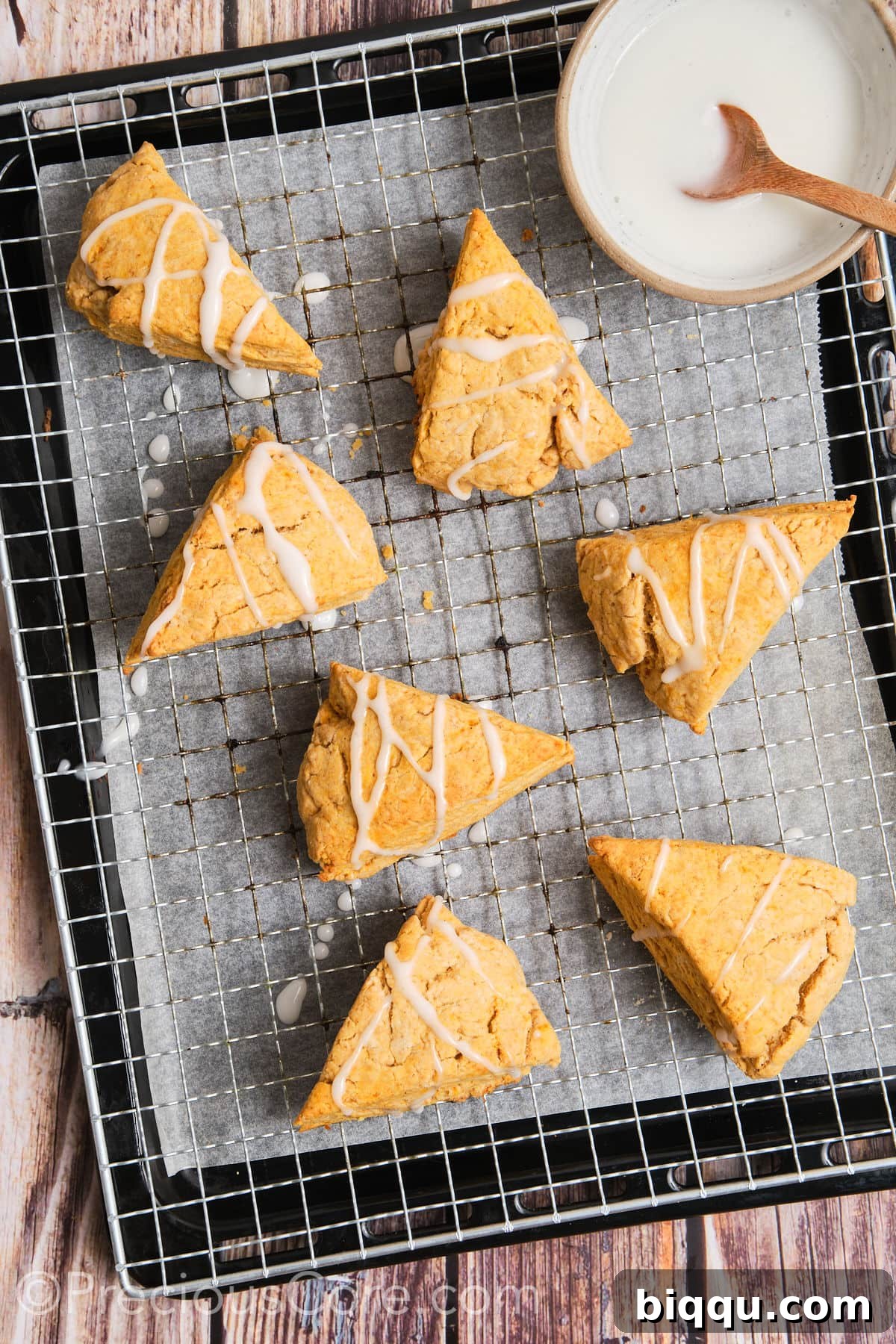 Sweet potato scones with white glaze artfully drizzled on top.