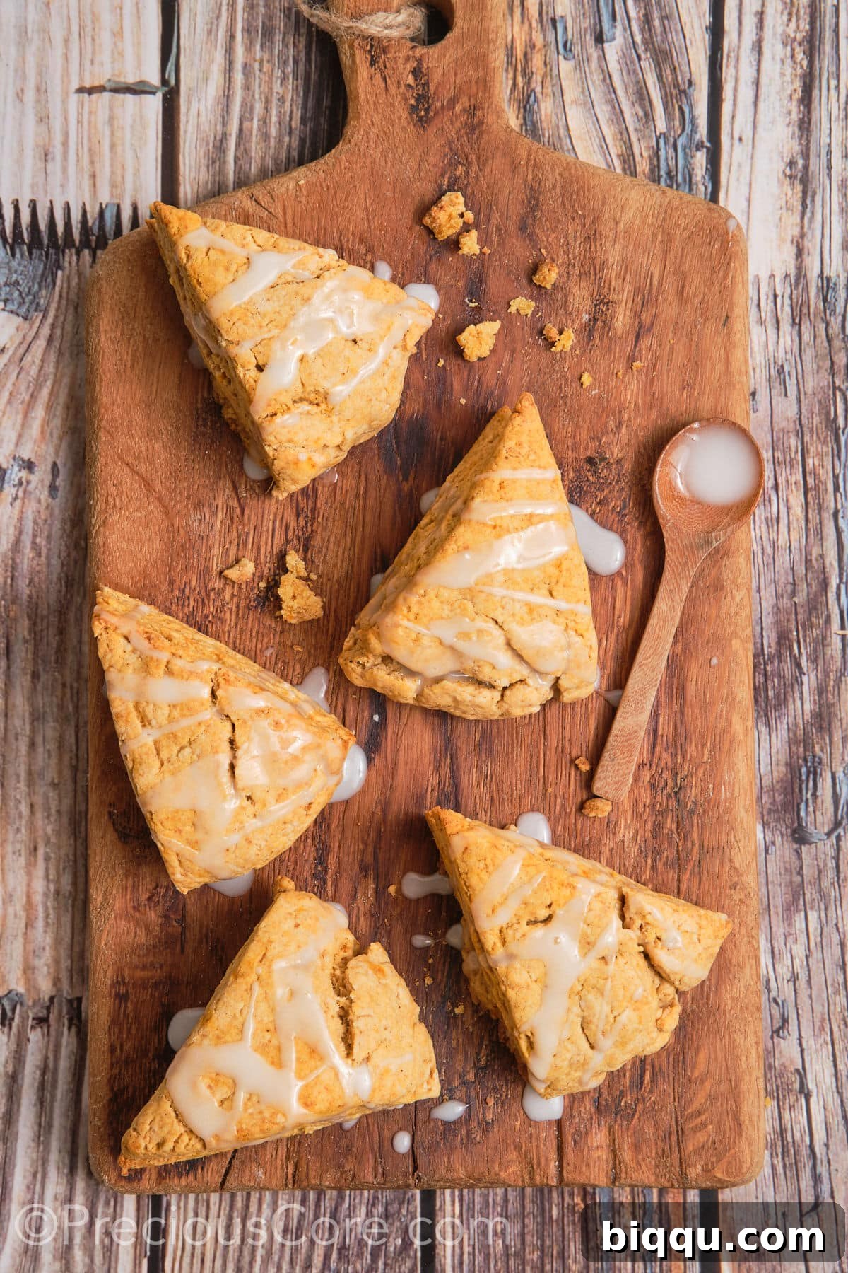 Fluffy sweet potato scones with white glaze drizzled on top, ready for serving.