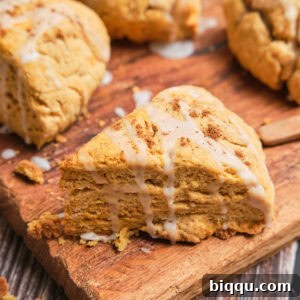 A triangle sweet potato scone with a white glaze on top.