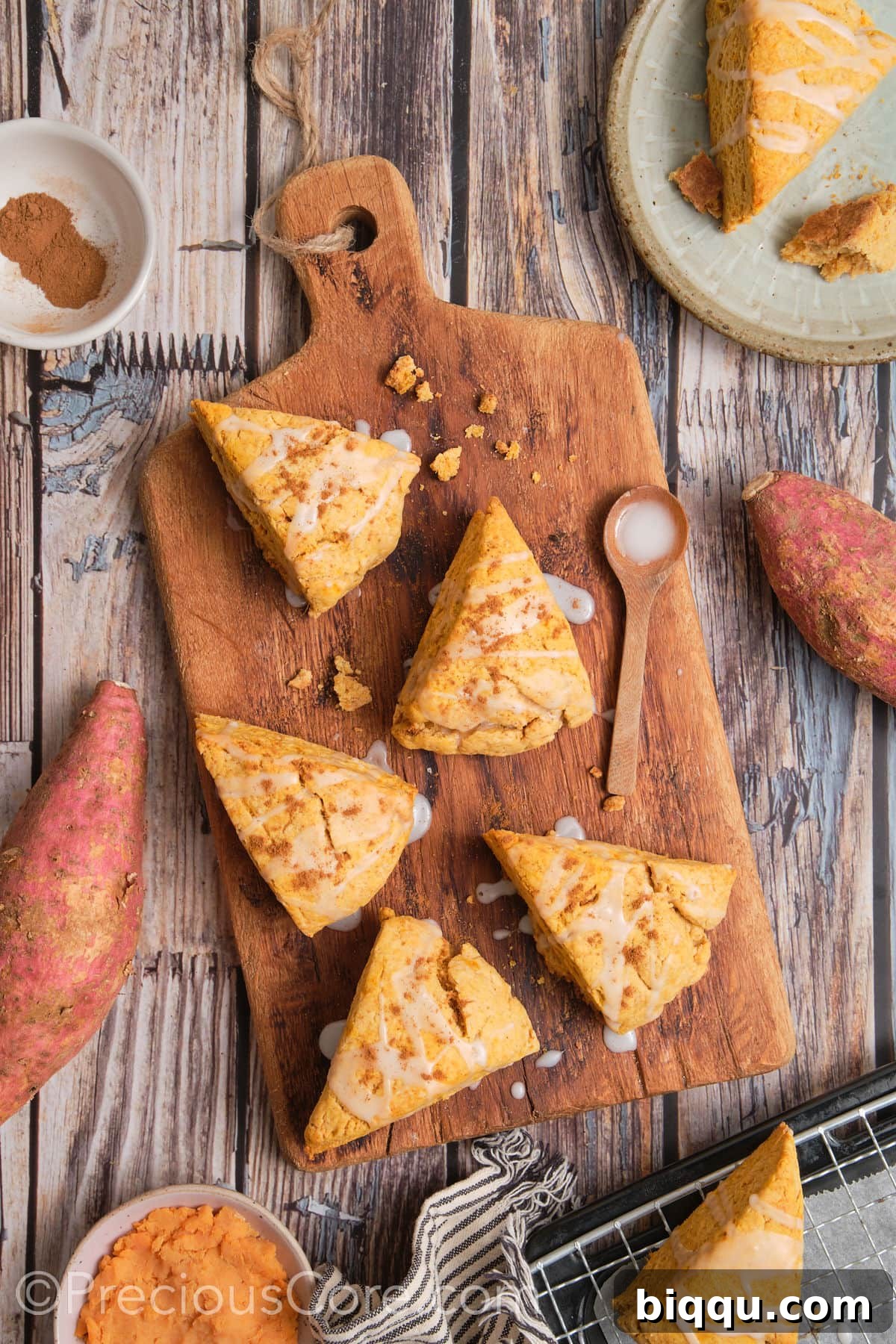 Freshly baked sweet potato scones arranged on a wooden chopping board.