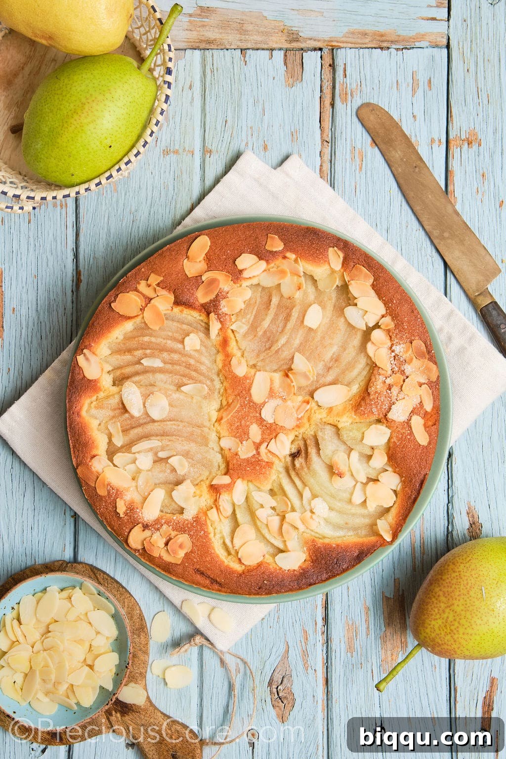 almond and pear cake on a serving plate.