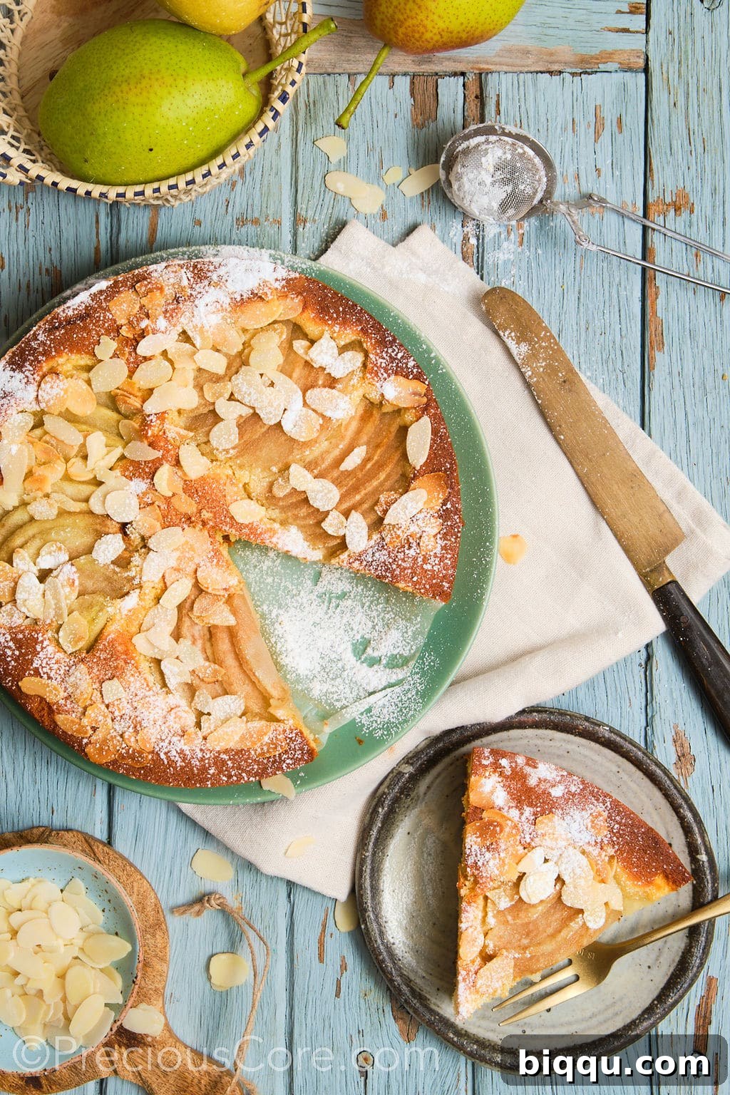pear and almond cake, topped with a dusting of icing sugar, sliced and served.