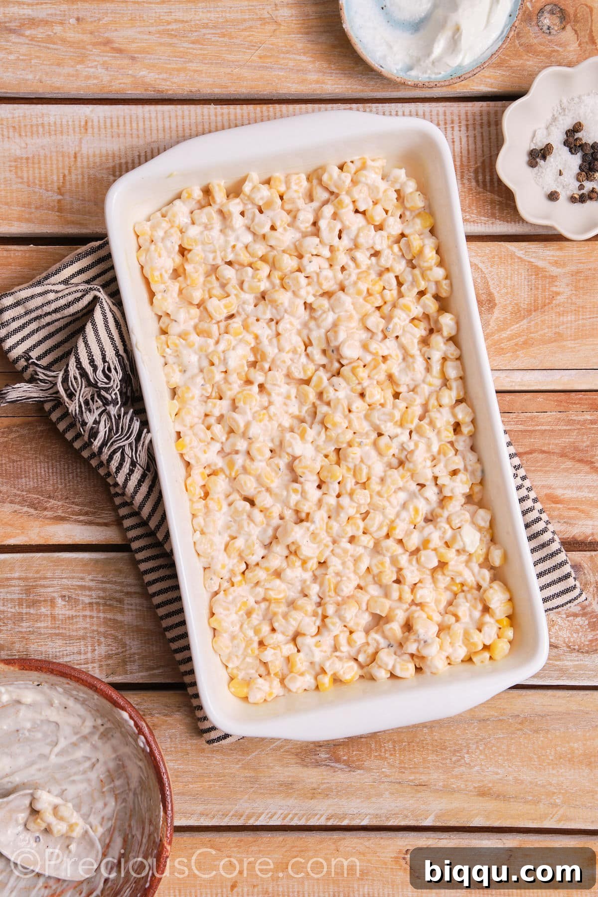 Creamy corn mixture evenly spread in a baking dish, ready for the oven.
