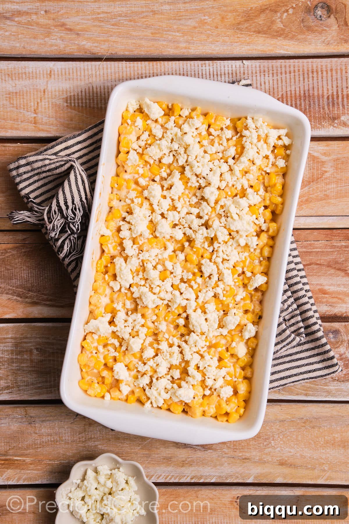 Baked corn casserole generously topped with crumbled queso fresco.