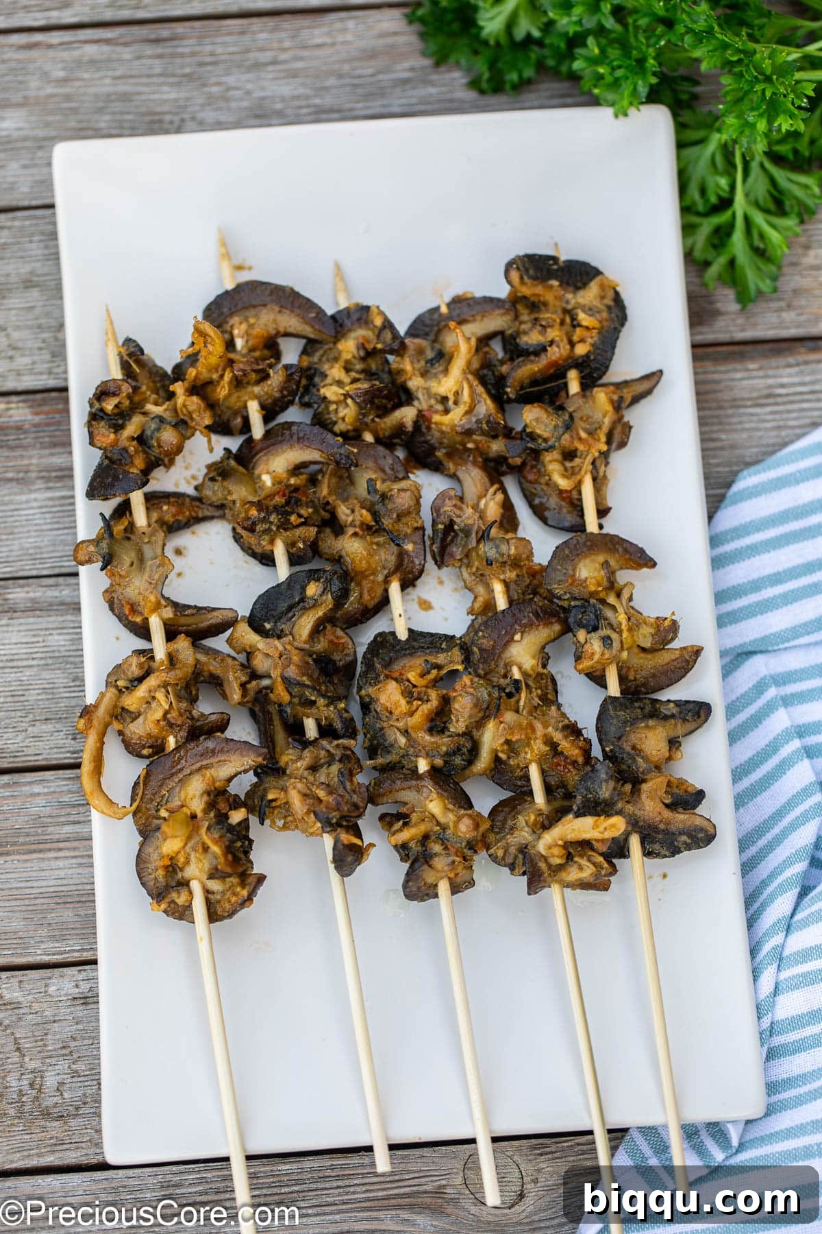 Cameroonian street food snails expertly threaded on bamboo skewers, ready for grilling or serving.