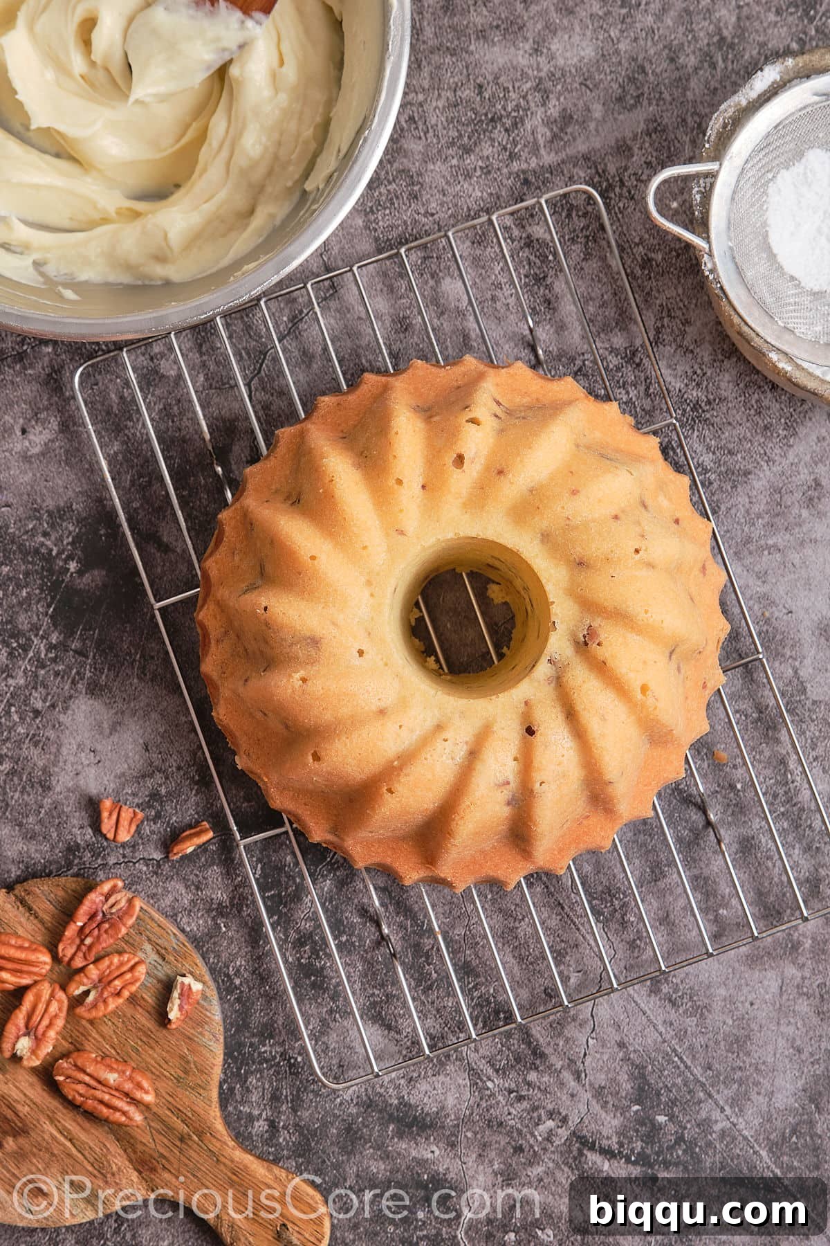 The baked Butter Pecan Pound Cake cooling on a wire rack after being removed from the pan.