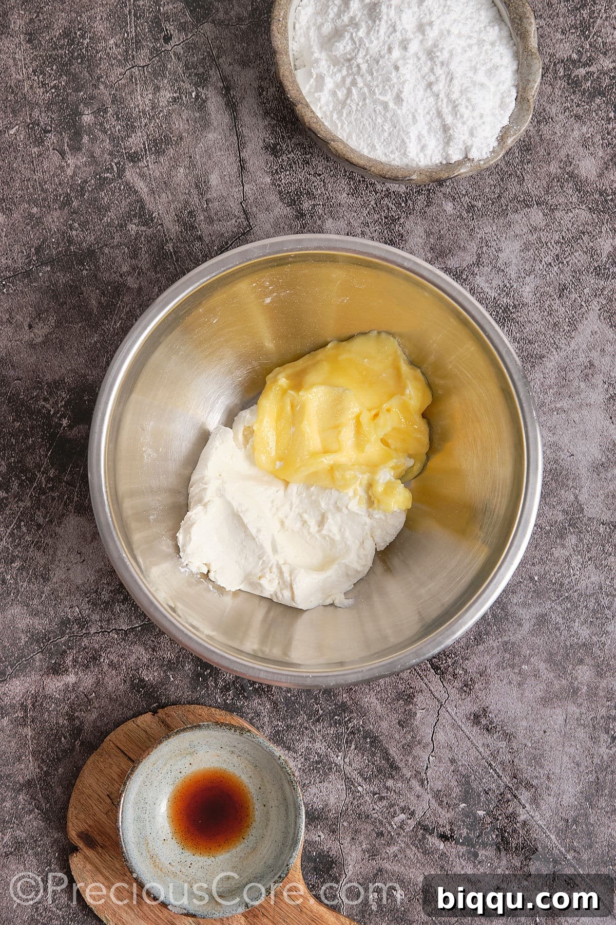 Softened cream cheese and butter in a mixing bowl, ready to be beaten for the frosting.