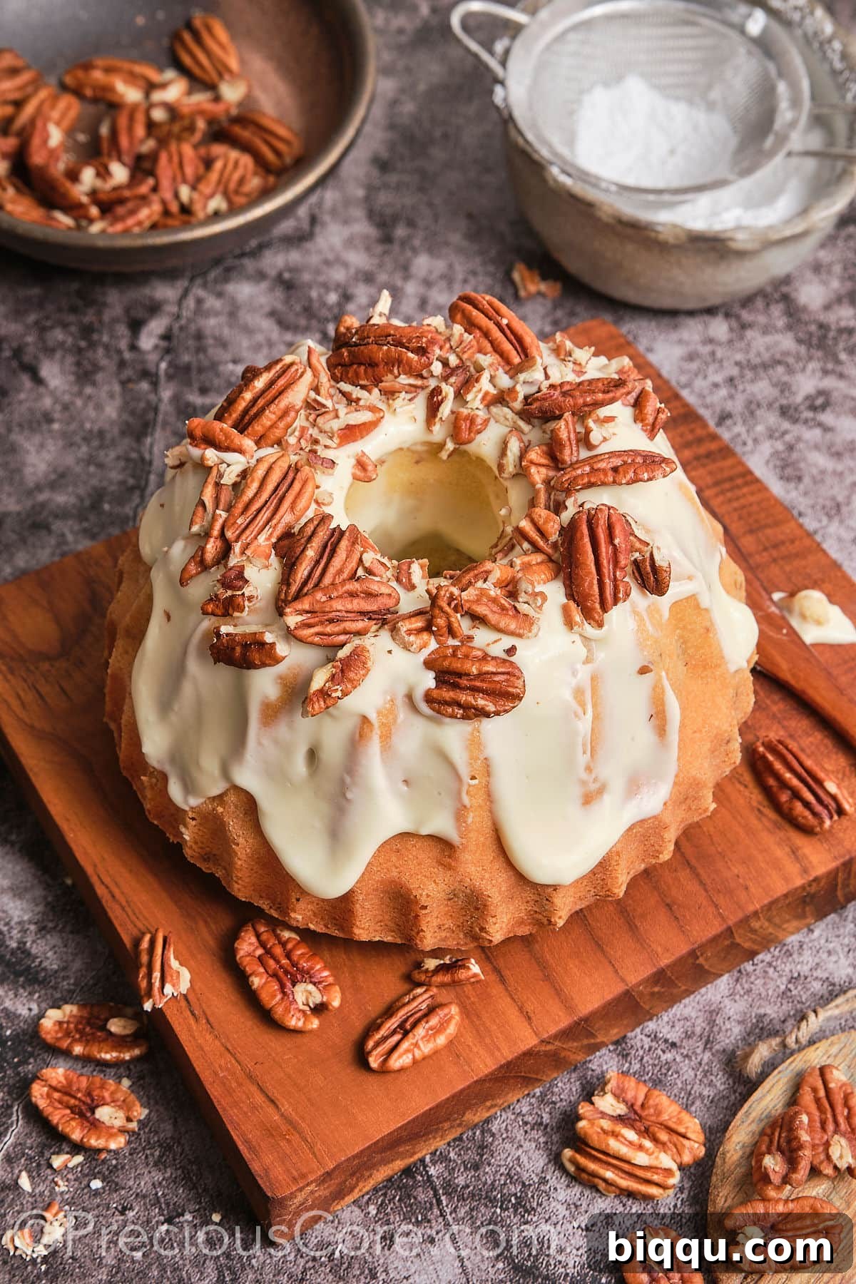 A stunning Butter Pecan Pound Cake presented on a rustic wooden plank, ready for serving.