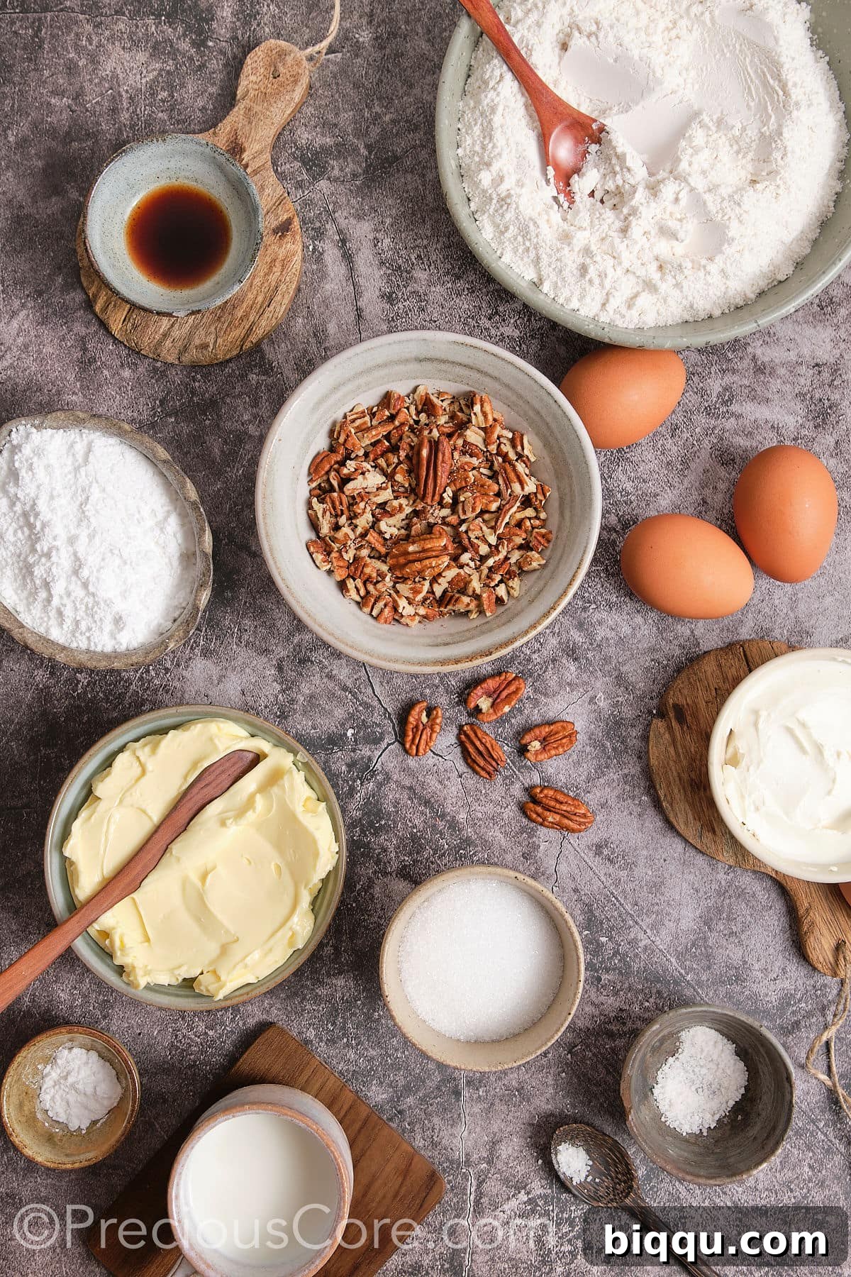 Various ingredients for Butter Pecan Pound Cake, including flour, sugar, butter, eggs, milk, pecans, and cream cheese.