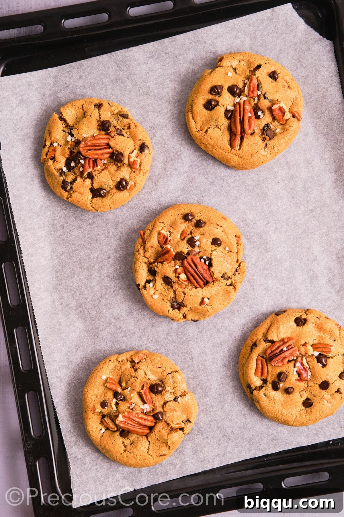 Brown Butter Pecan Bliss Cookies 15 Perfectly baked brown butter pecan cookies on a baking sheet.