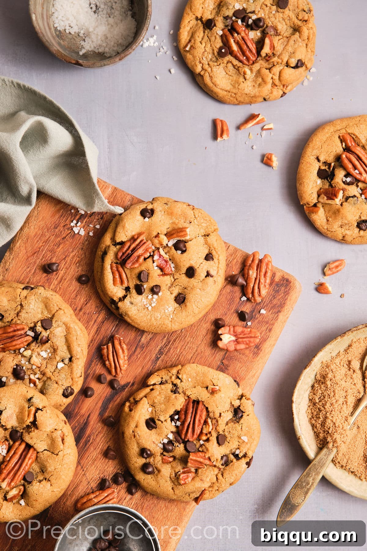 Brown Butter Pecan Bliss Cookies 16 Cooled butter pecan cookies on a chopping board.