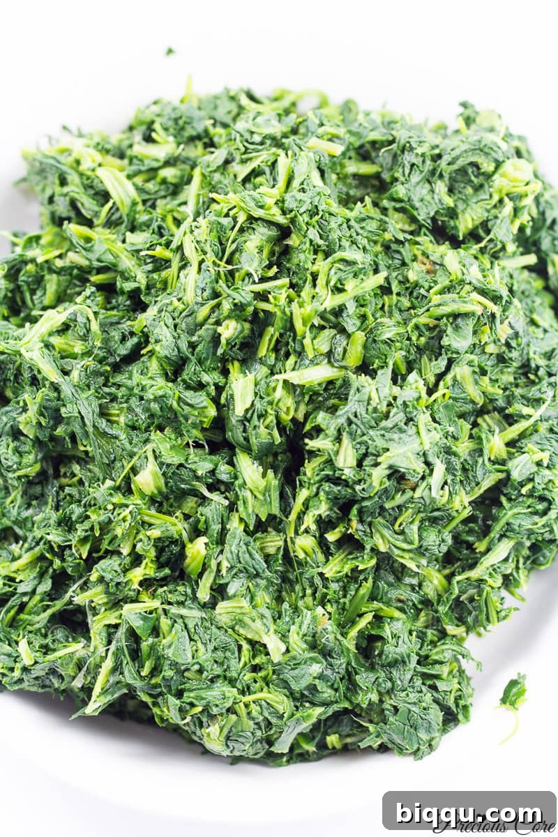 Close-up of thawed and squeezed chopped spinach, ready for cooking