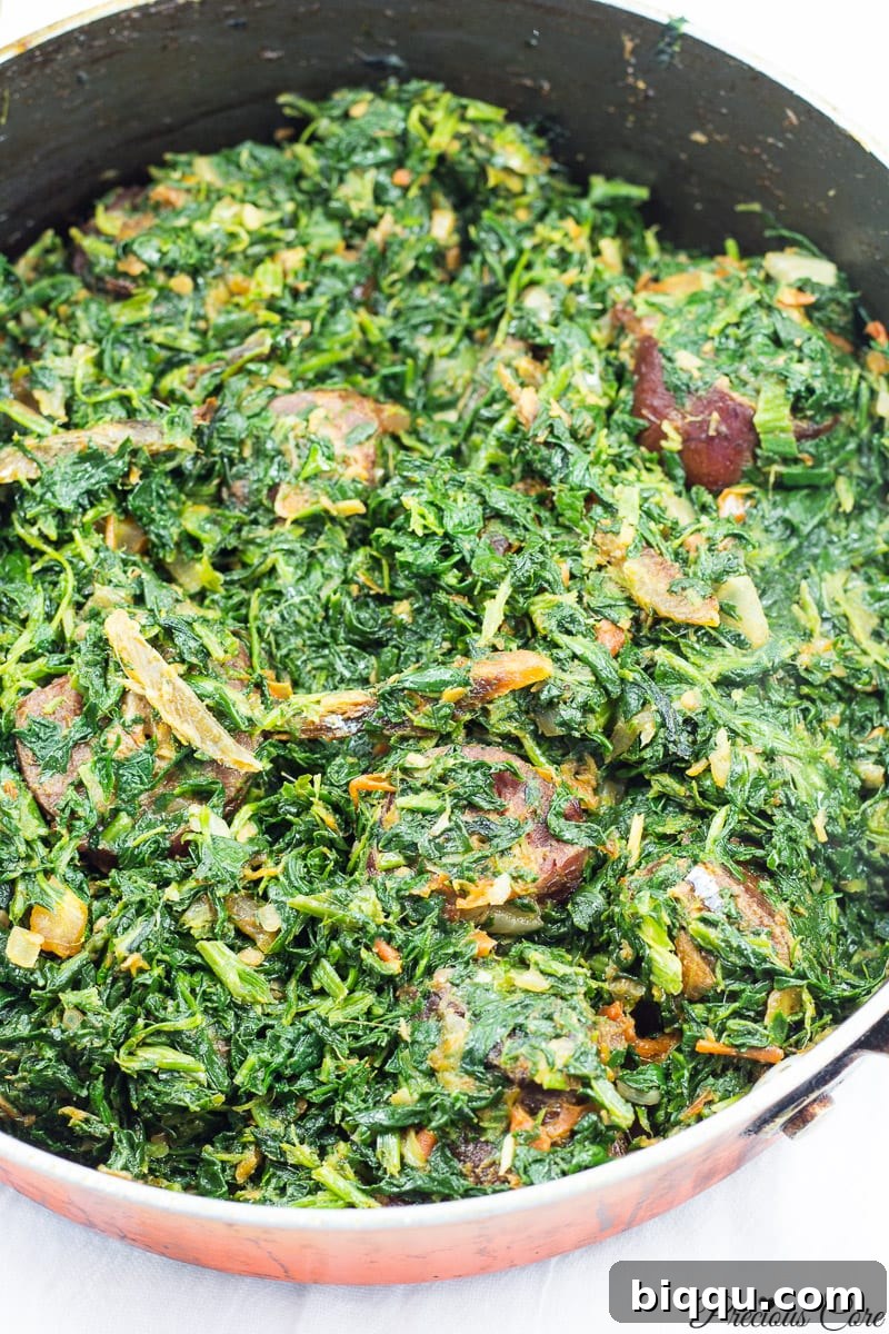 A freshly cooked pot of African Stewed Spinach, rich and vibrant
