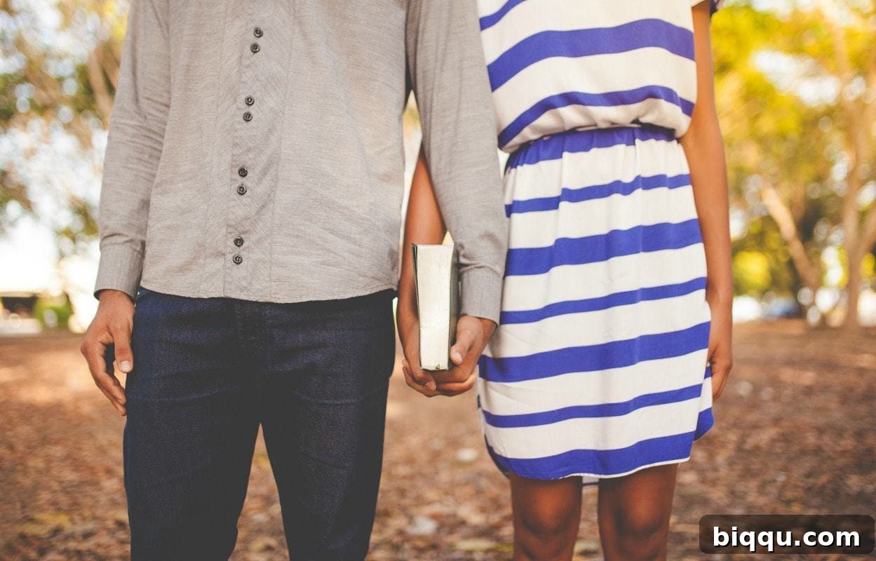 A couple holding hands and a Bible, symbolizing the foundation of faith in marriage.