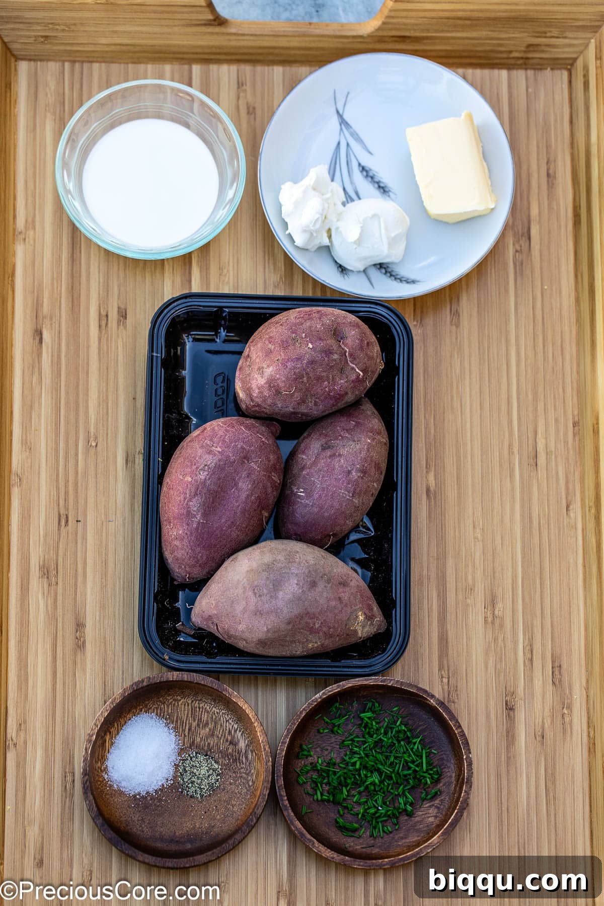 A flat lay of fresh ingredients including Japanese sweet potatoes, butter, milk, cream cheese, salt, pepper, and chives.