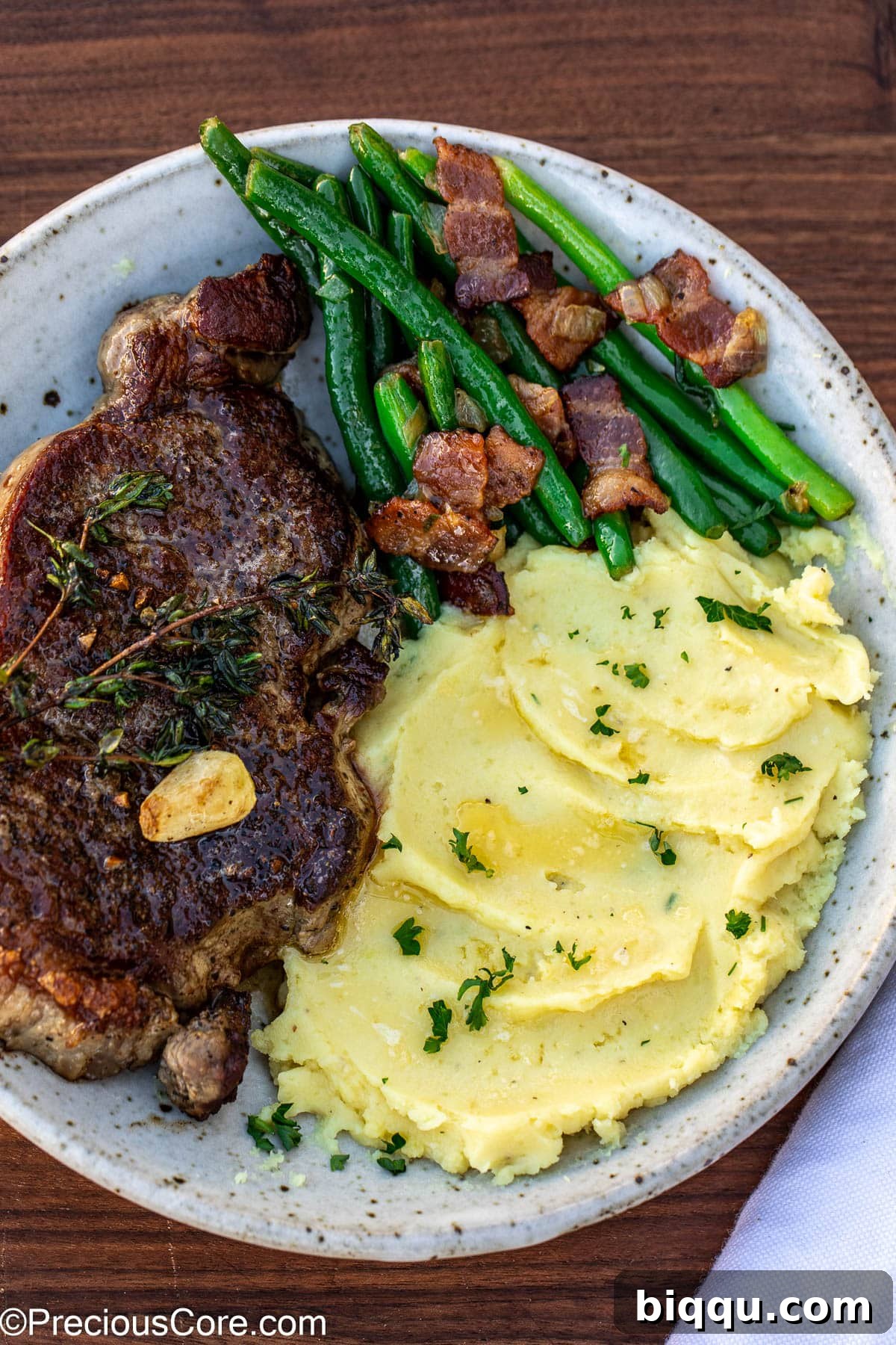 Bacon green beans served with steak and mashed potatoes.