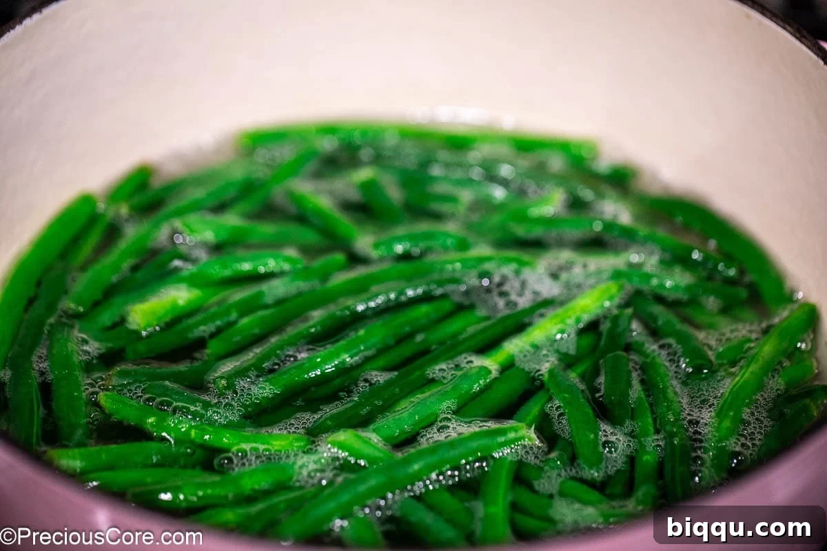 Green beans in a pot with water.