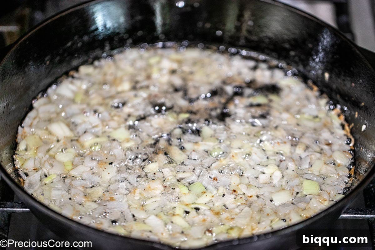 Onions sautéing in cast iron skillet.