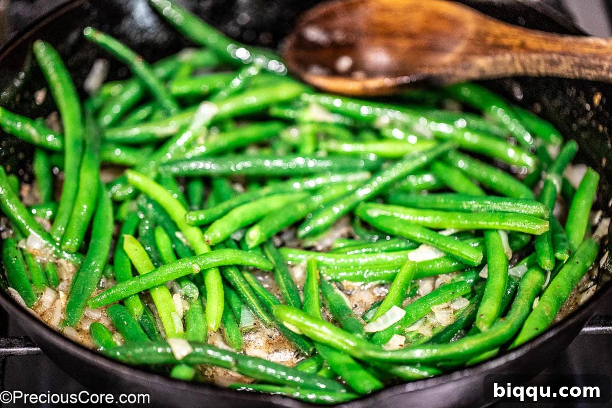 Green beans added to skillet.