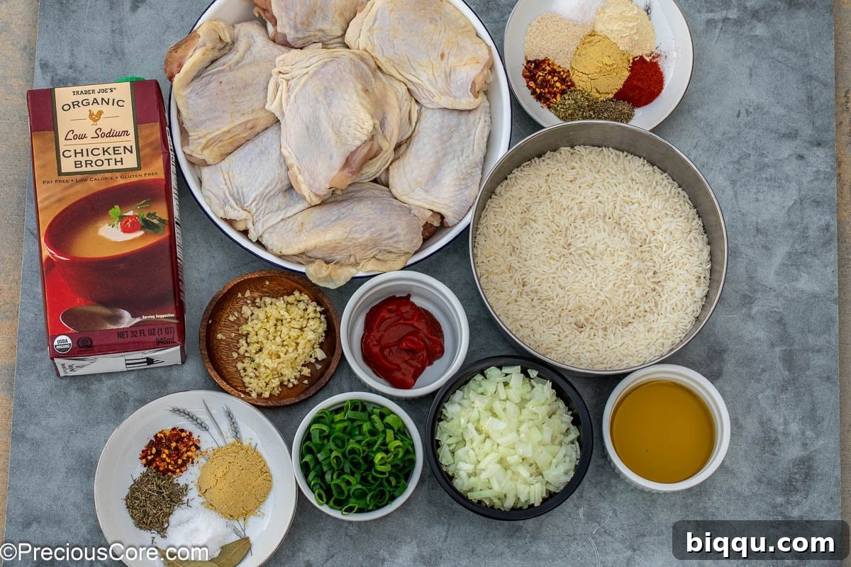 A flat lay of all the ingredients needed for the one pot chicken thighs and rice recipe, neatly arranged.