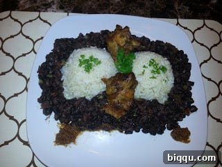 Gourmet Plated Rice and Beans with Fried Chicken and Pepper Sauce