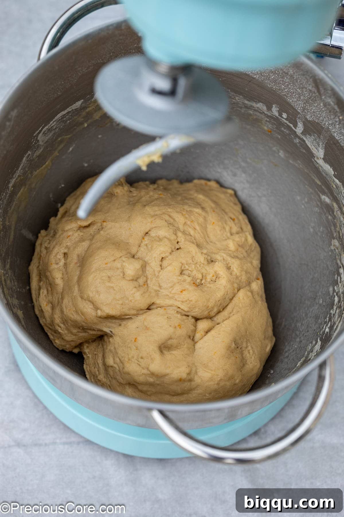 Chin Chin dough mixing smoothly in a stand mixer bowl, showcasing its readiness for the next steps.