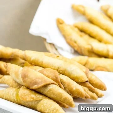 Plate and basket of crispy Cameroonian fish rolls, an ultimate snack