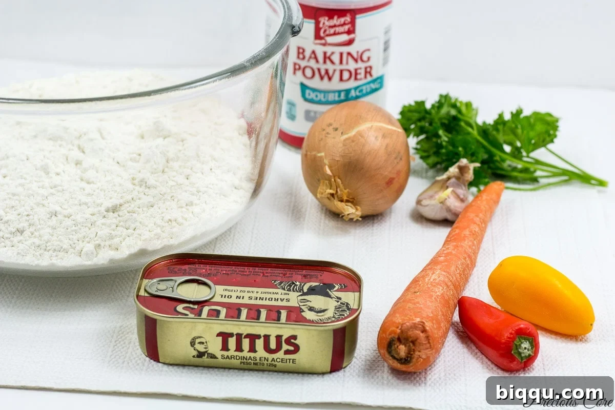 Selection of fresh ingredients for Cameroonian Fish Rolls, including vegetables and canned sardines