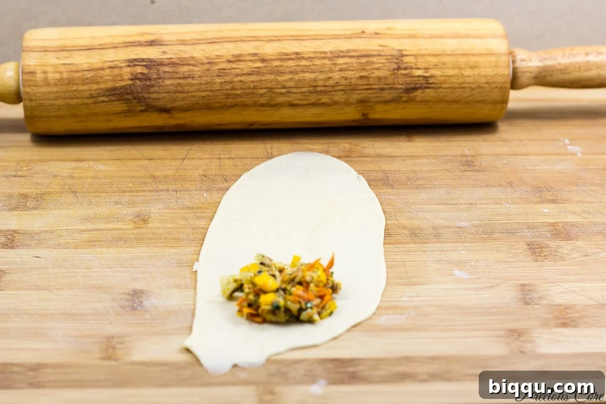 Step-by-step guide on how to place filling and start rolling Cameroonian fish rolls